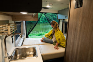 Woman in luxury RV looking at the view of a national park