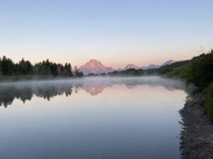 Grand Teton National Park at sunrise at Oxbow Bend with mountains reflected in water